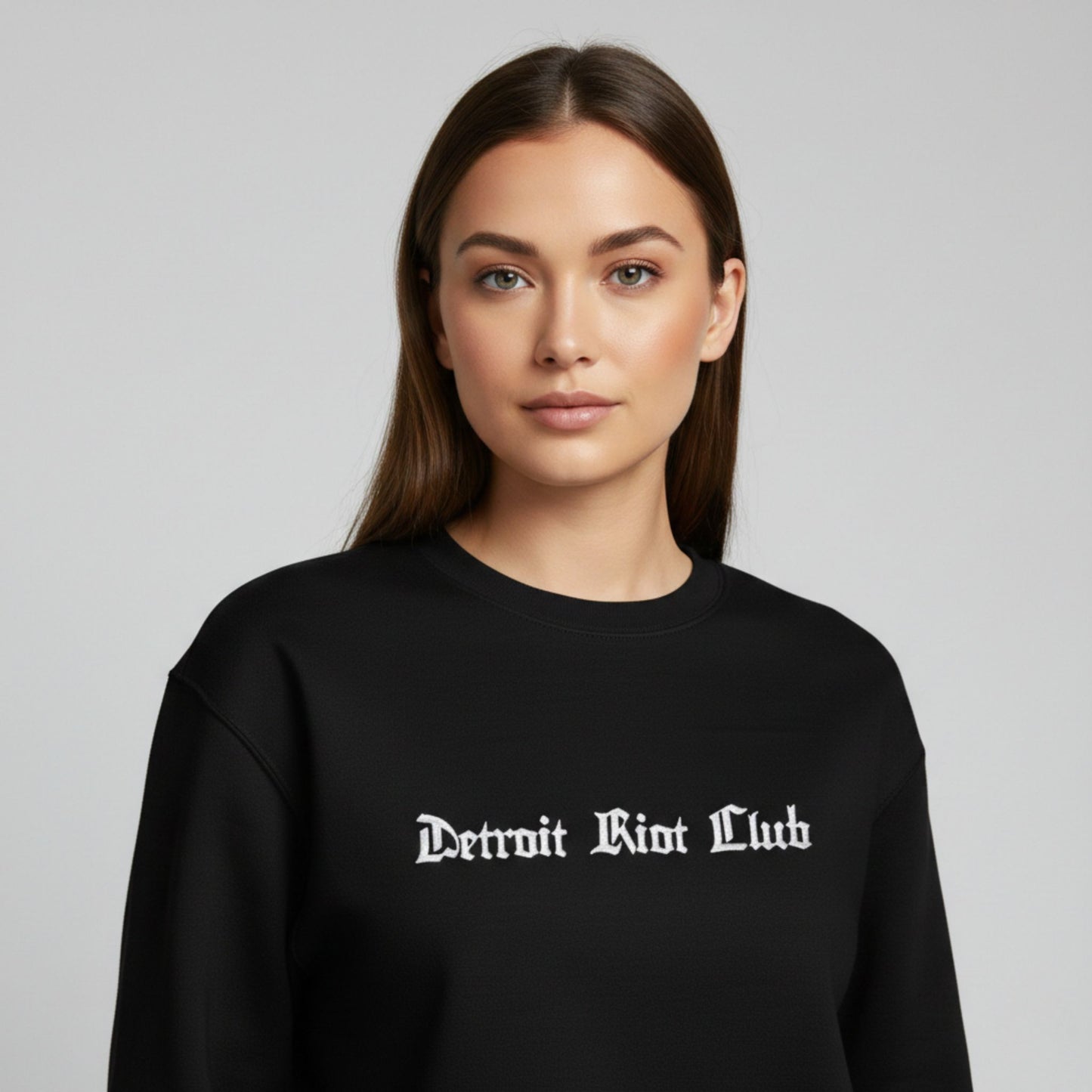 "Portrait view of female model in the Detroit Riot Club 8.5oz Archival Crewneck."