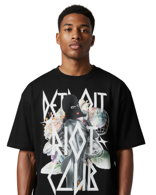 "Close-up front shot portrait of male model in the Masked Reality Tee. Emphasizing the crisp, high-contrast surrealist branding and ultra-smooth 100% cotton face."