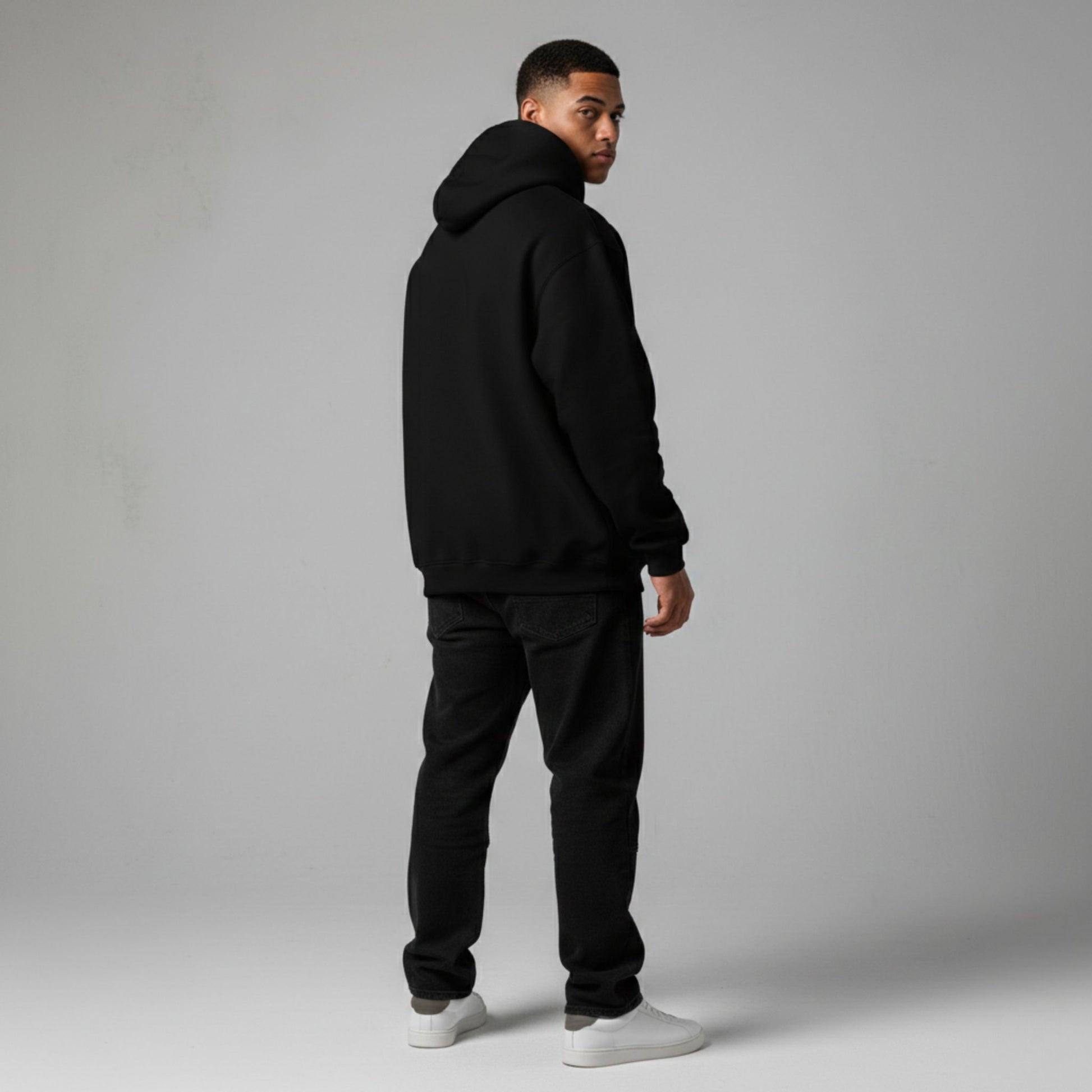 Detroit Riot Club Aether Liger Hoodie in Void Black, 9.4oz heavyweight hardware, male model rear view, full silhouette, premium streetwear.